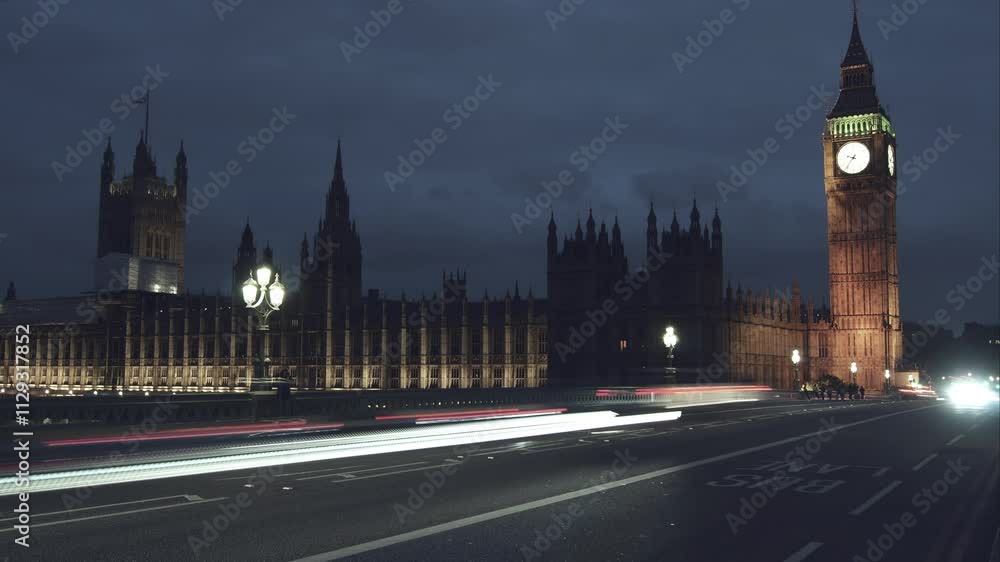 Car traffic at night at the entrance to Westminster Bridge and the illuminated clock tower Big Ben, time lapse. Car traffic at night at the entrance to Westminster Bridge and the illuminated clock tower Big Ben, time lapse.