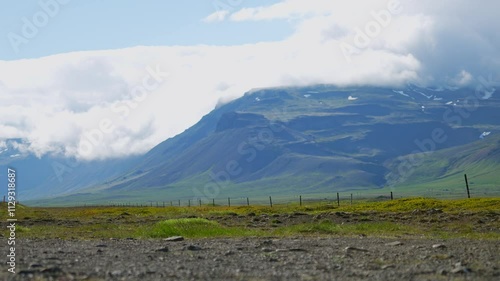 Driver of SUV makes stop on road against mountain in summer
