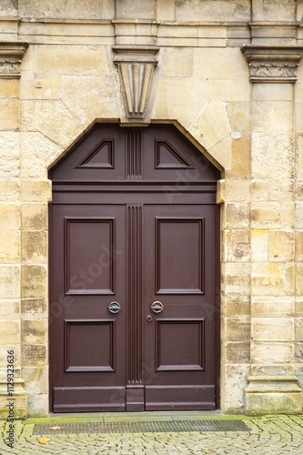 Elegant brown double door enhancing a stone wall facade