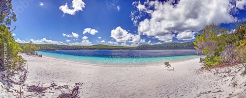 Panoramic view of Lake McKenzie on Fraser Island with white sand, crystal-clear water, and lush greenery photo