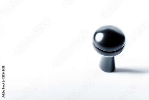 A close-up shot of a black knob on a white surface, ideal for use in product or design imagery