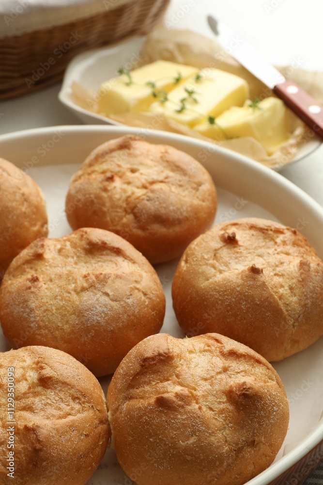Baking dish with homemade tasty buns on table, closeup Baking dish with homemade tasty buns on table, closeup
