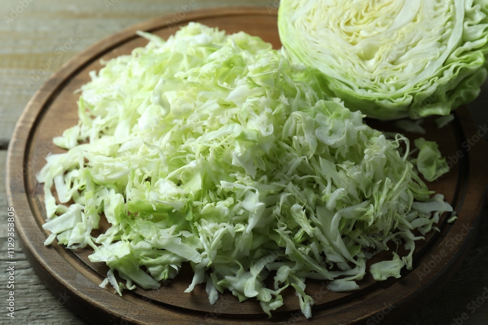 Fresh shredded cabbage on wooden table, closeup Fresh shredded cabbage on wooden table, closeup