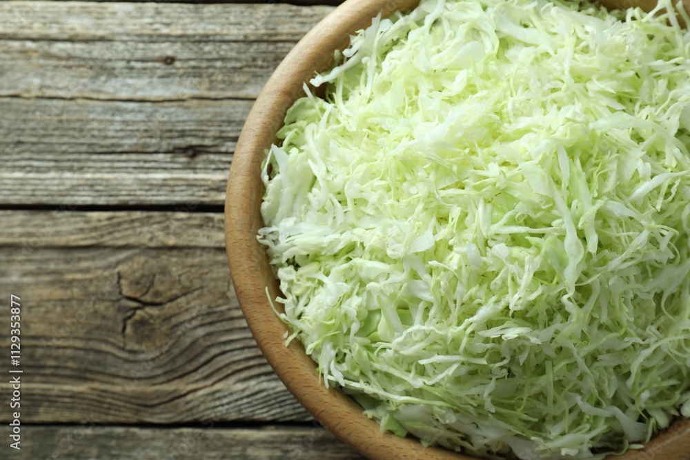 Fresh shredded cabbage on wooden table, top view. Space for text Fresh shredded cabbage on wooden table, top view. Space for text
