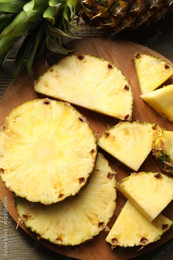 Slices of fresh ripe pineapple on wooden table, top view Slices of fresh ripe pineapple on wooden table, top view