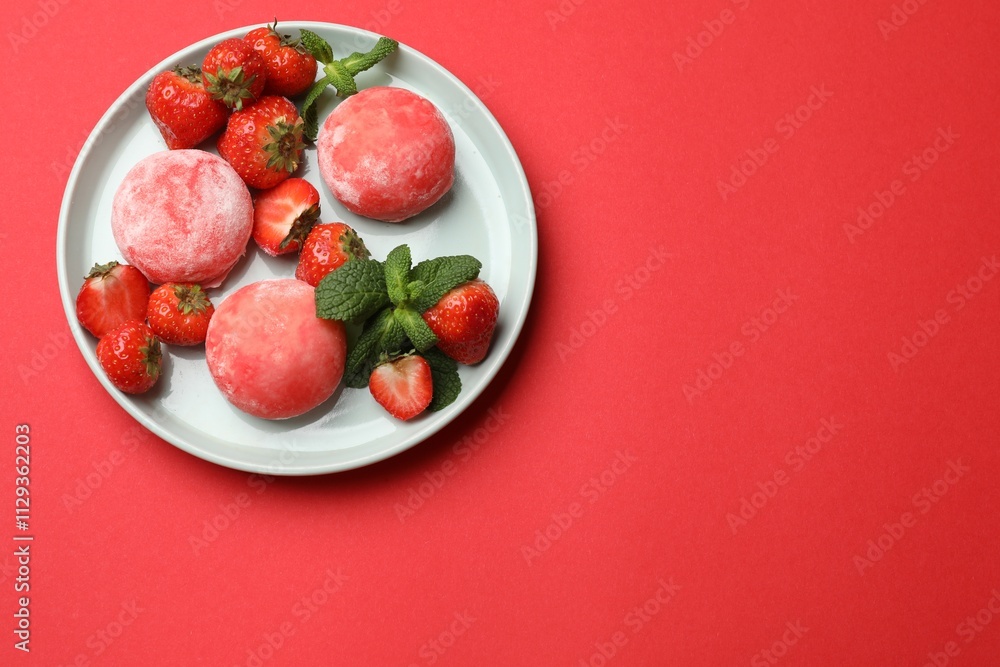 Delicious mochi, strawberries and mint on red background, top view. Space for text Delicious mochi, strawberries and mint on red background, top view. Space for text