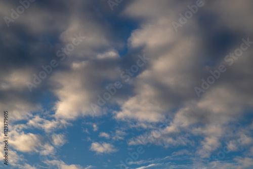 Bright Blue Sky with Soft White Clouds in a Serene Atmosphere
