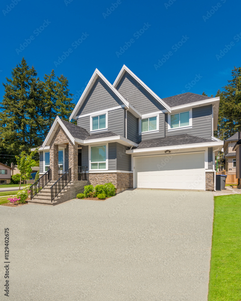 Two story stucco luxury house with nice summer landscape in Vancouver, Canada, North America. Day time on June 2024. Two story stucco luxury house with nice summer landscape in Vancouver, Canada, North America. Day time on June 2024.