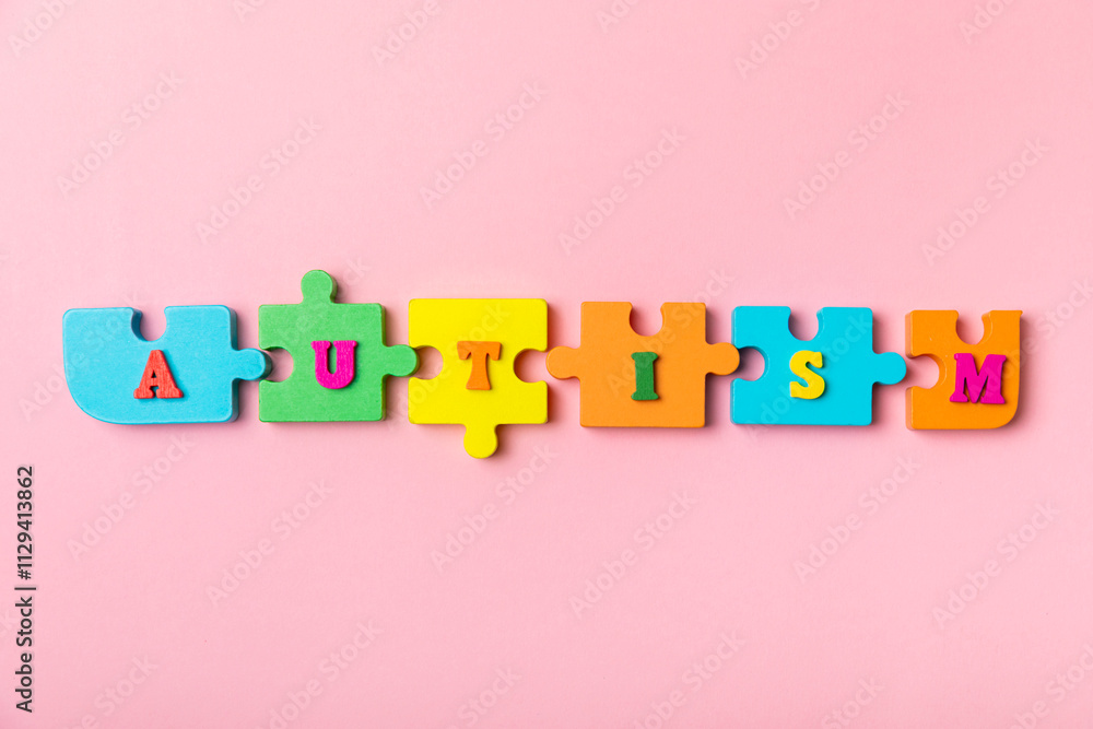 Autism awareness day.2 April world autism awareness day background.Design element.Care Awareness campaign for Autism.AUTISM text with colorful wooden puzzles, letters and cubes.Space for text.Top view Autism awareness day.2 April world autism awareness day background.Design element.Care Awareness campaign for Autism.AUTISM text with colorful wooden puzzles, letters and cubes.Space for text.Top view