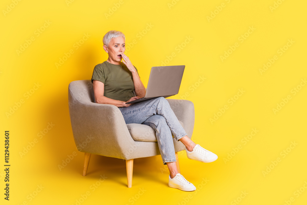 Full length photo of attractive shocked lady dressed khaki t-shirt reading news modern gadget empty space isolated yellow color background Full length photo of attractive shocked lady dressed khaki t-shirt reading news modern gadget empty space isolated yellow color background