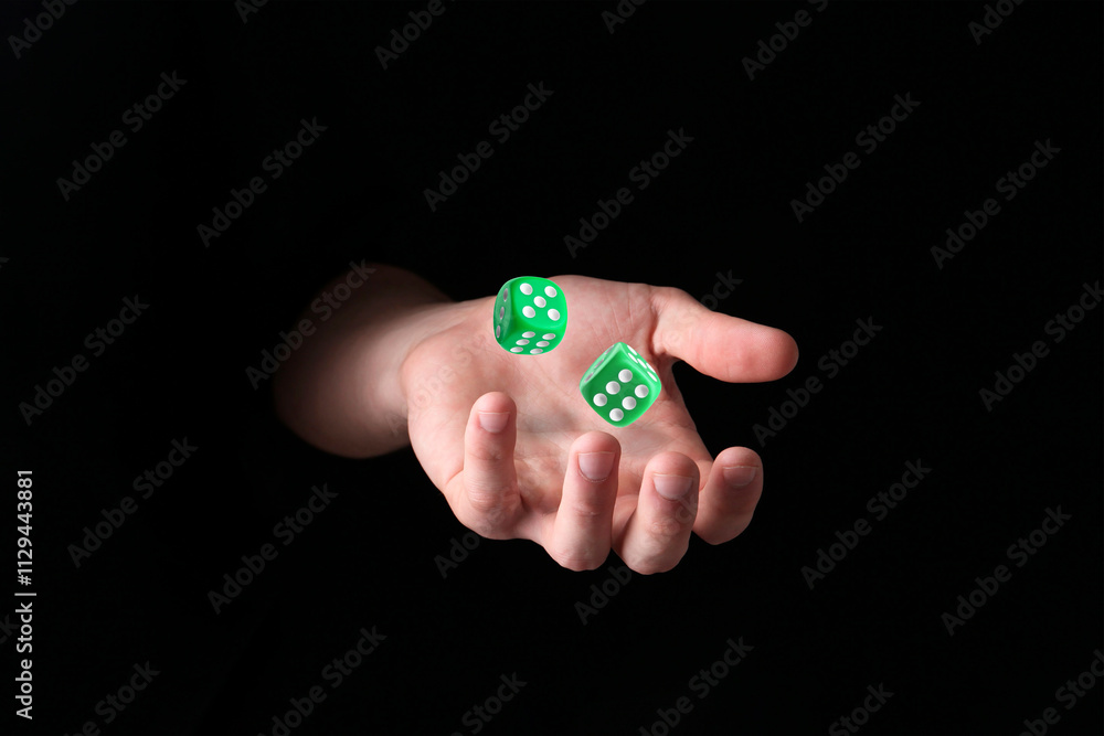 Man throwing green dice in darkness, closeup Man throwing green dice in darkness, closeup