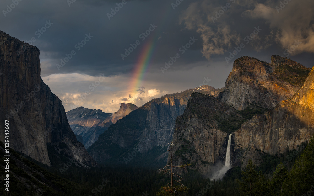 Yosemite valley evening panorama from tunnel view point with clouds and rainbow, California