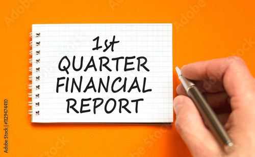 1st quarter financial report symbol. Concept words 1st quarter financial report on beautiful white note. Beautiful orange background. Business 1st quarter financial report concept. Copy space. photo