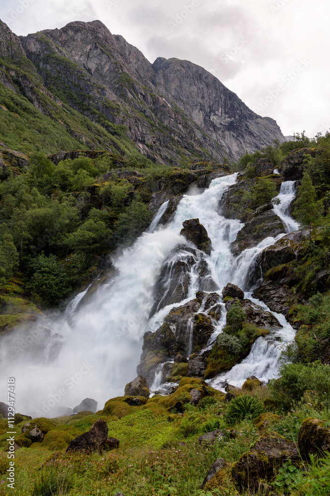 Obraz premium View of the Kleivafossen Waterfall near Briksdal Glacier in Norway.
