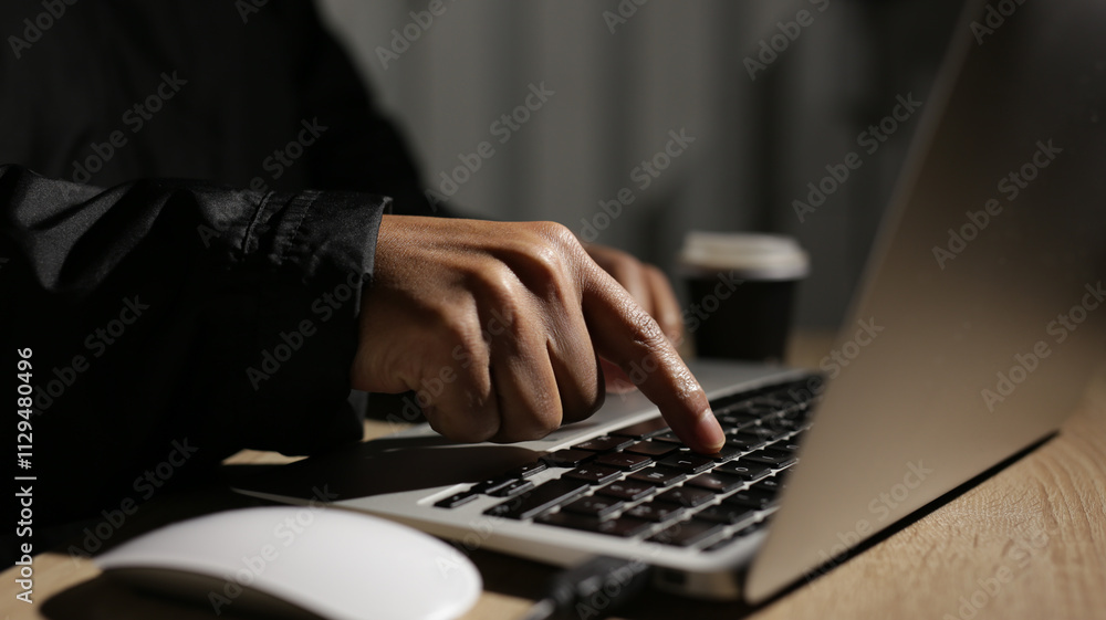 Programmer writing code on laptop keyboard in dark office at night Programmer writing code on laptop keyboard in dark office at night