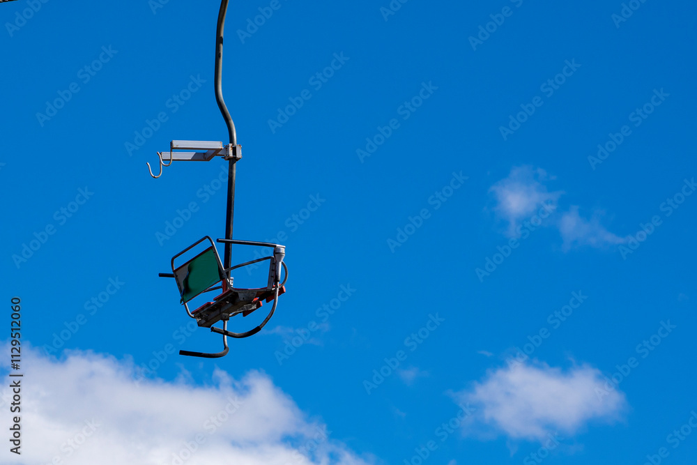 observation chair on a flat lift high in the sky. leisure.ski boots close up on the slope observation chair on a flat lift high in the sky. leisure.ski boots close up on the slope