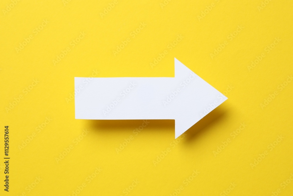 Paper arrow on color background, top view Paper arrow on color background, top view