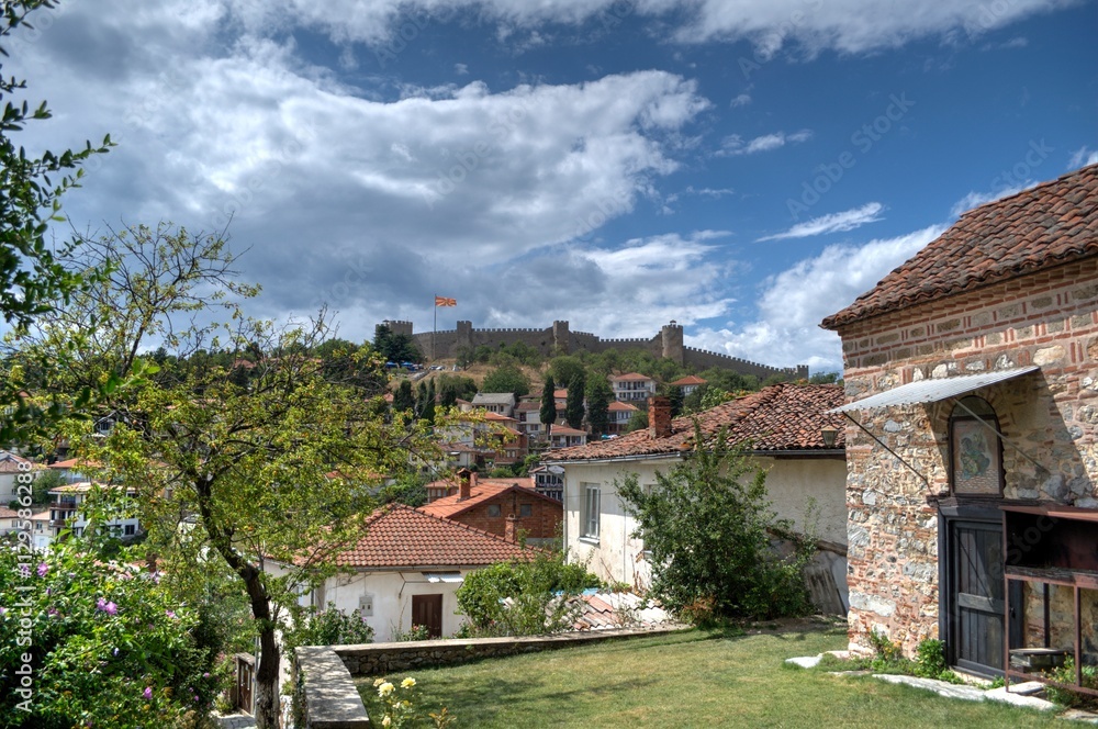 Historical part of old town Ohrid is located next to the lake and spread all over the hill with fortress of king Samuel at the top. Dramatic clouds in the sky. Historical part of old town Ohrid is located next to the lake and spread all over the hill with fortress of king Samuel at the top. Dramatic clouds in the sky.
