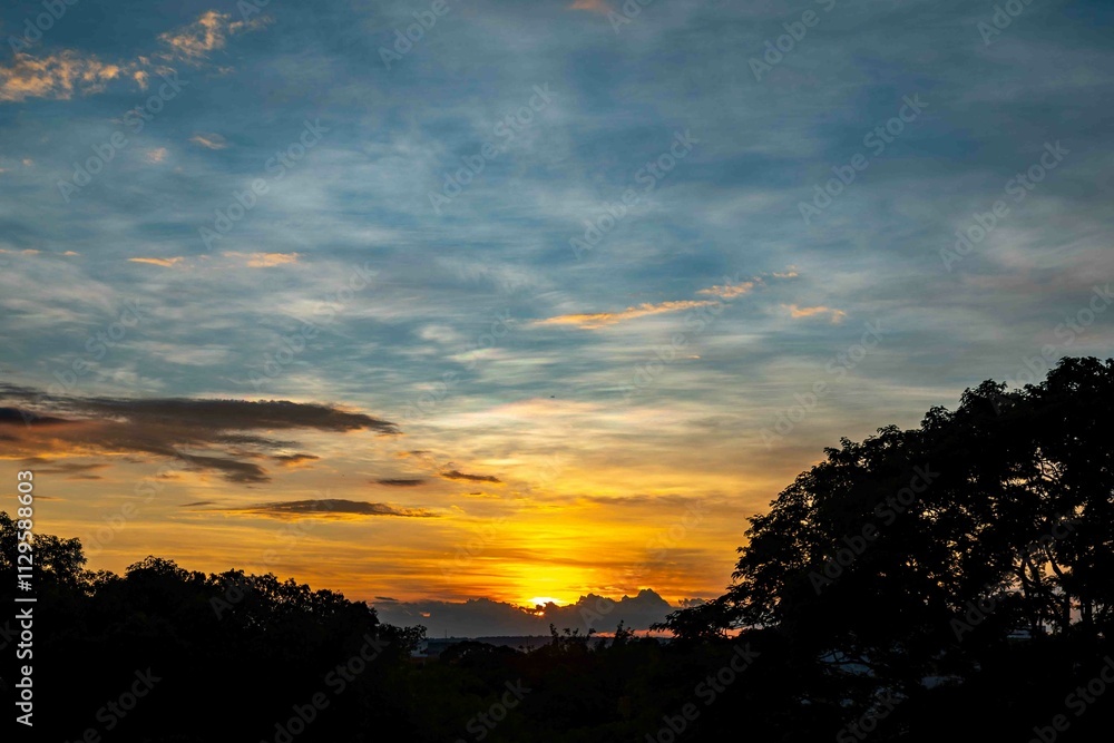 Sunrise with intense natural orange lights and idyllic dramatic scenery Sunrise with intense natural orange lights and idyllic dramatic scenery