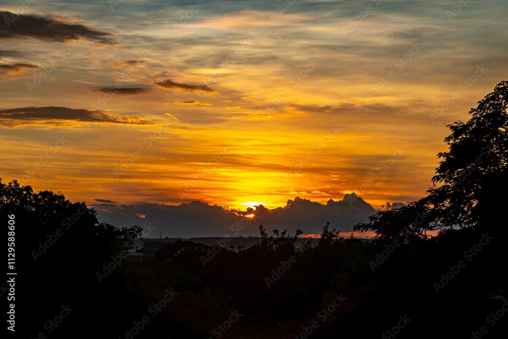 Sunrise with intense natural orange lights and idyllic dramatic scenery Sunrise with intense natural orange lights and idyllic dramatic scenery