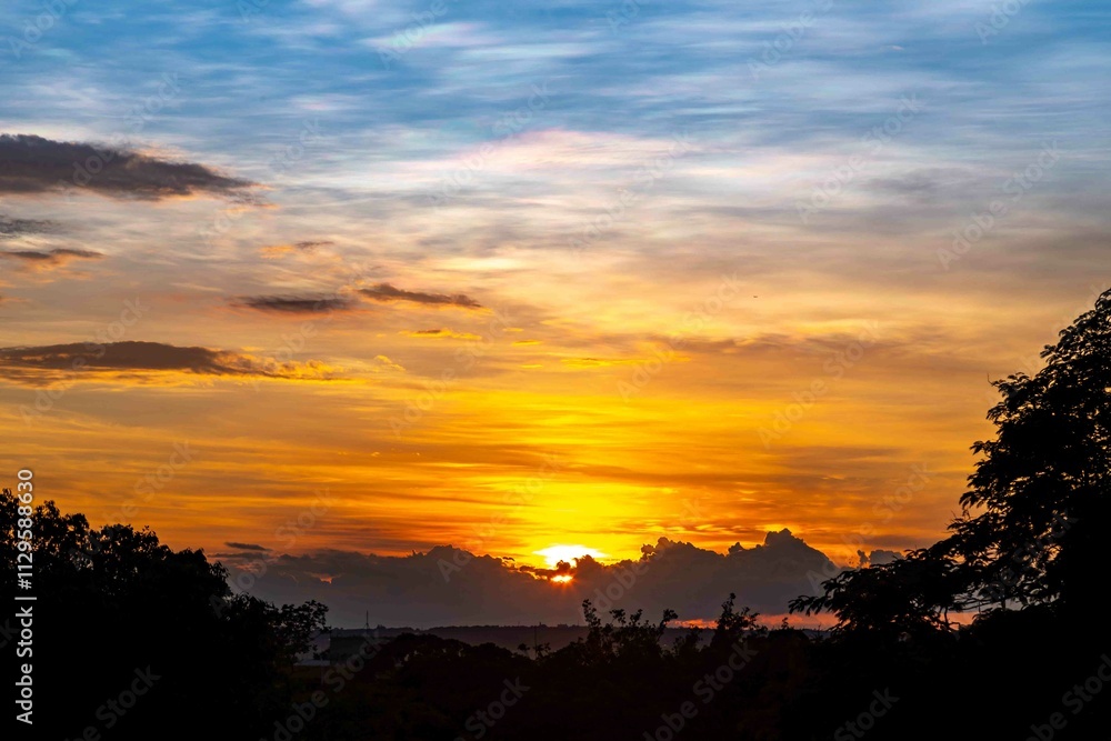 Sunrise with intense natural orange lights and idyllic dramatic scenery Sunrise with intense natural orange lights and idyllic dramatic scenery