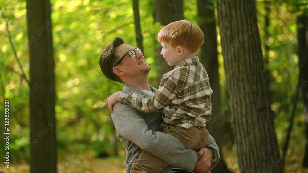 A father joyfully carries his son through a vibrant forest scene, beautifully showcasing the bond of family in nature A father joyfully carries his son through a vibrant forest scene, beautifully showcasing the bond of family in nature
