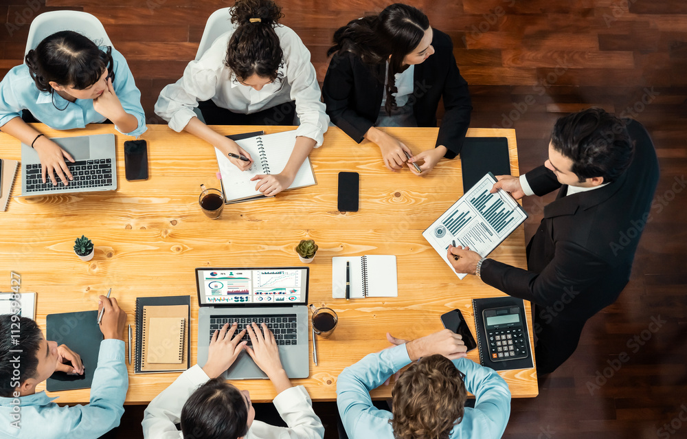 Obraz premium Panorama top view diverse group of business analyst team analyzing financial data report paper on meeting table. Chart and graph dashboard by business intelligence analysis. Meticulous