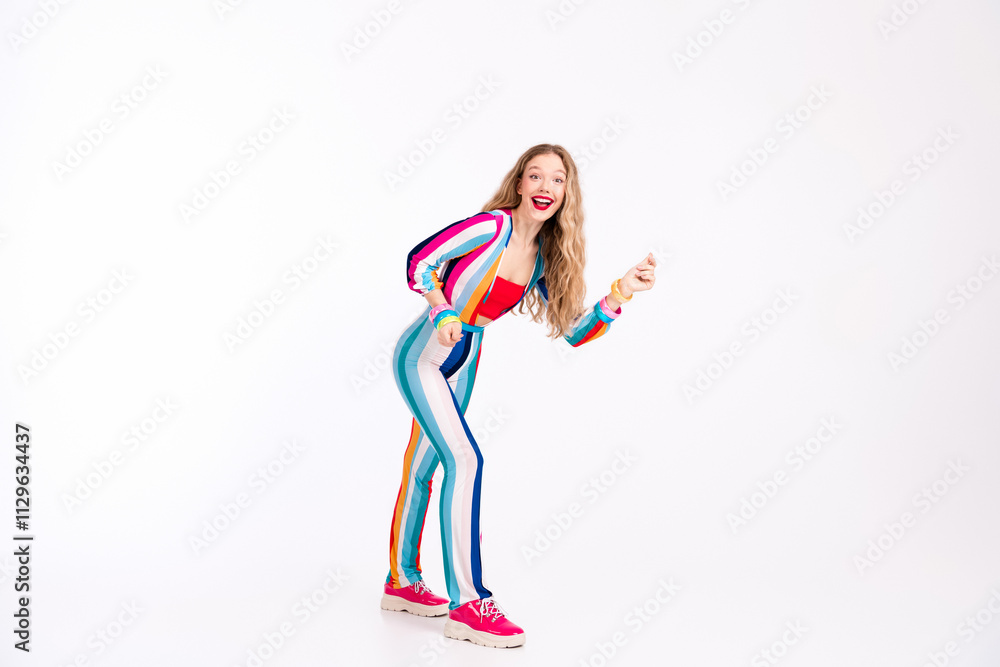 Young woman in colorful striped outfit poses energetically, showcasing vibrant fashion and lifestyle against a bright white background Young woman in colorful striped outfit poses energetically, showcasing vibrant fashion and lifestyle against a bright white background