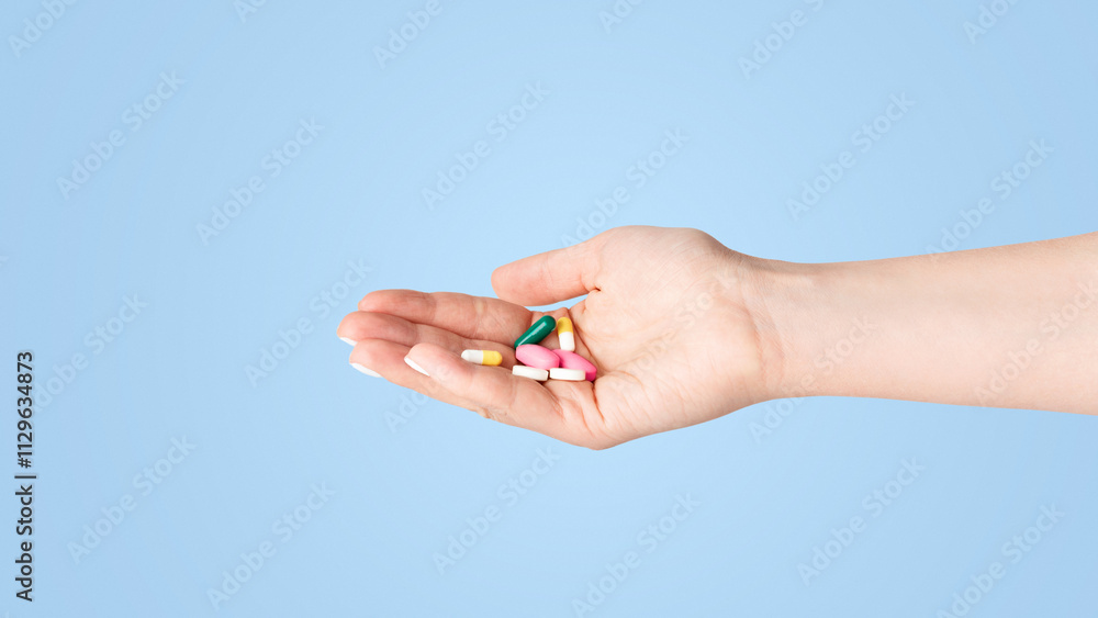 Virus treatment or suicide concept. Girl holding pile of pills on white background, close up Virus treatment or suicide concept. Girl holding pile of pills on white background, close up