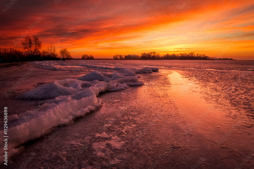 Winter landscape with sunset fiery sky. Composition of nature.