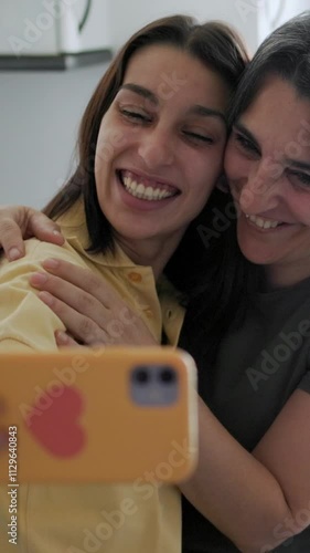 Hispanic mother and daughter taking selfies. Hispanic, single family