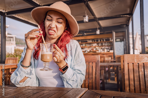 Obraz na płótnie Tourist making a disgusted face while drinking a bad coffee in an outdoor cafe w salonie