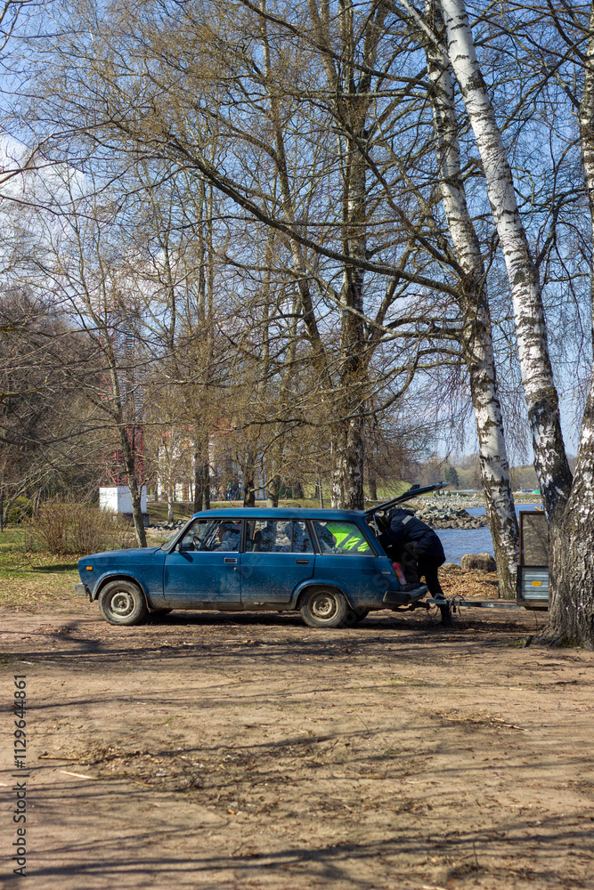 Fototapeta premium Man in the trunk of a car. Peterhof. Saint Petersburg