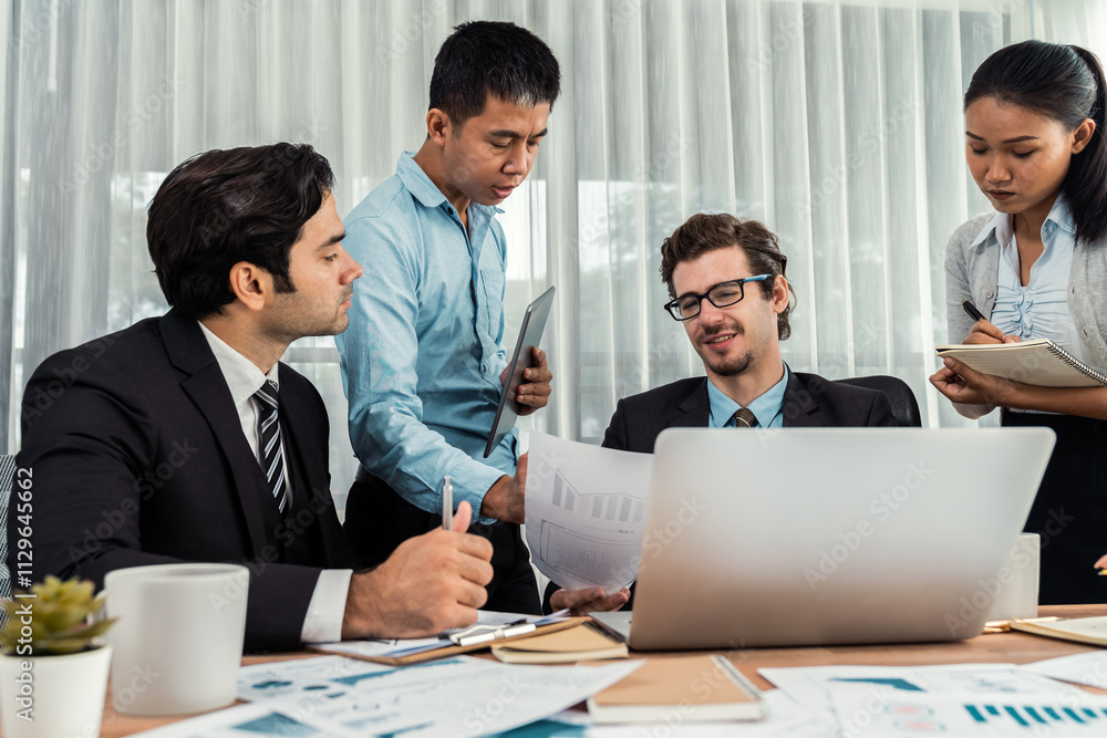 Diverse group of business analyst team analyzing financial data report paper on office table. Chart and graph dashboard by business intelligence analysis for strategic marketing planning Meticulous Diverse group of business analyst team analyzing financial data report paper on office table. Chart and graph dashboard by business intelligence analysis for strategic marketing planning Meticulous