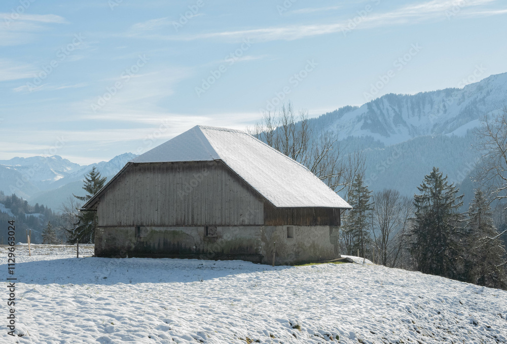 Swiss barn in the high snow capped alps 
