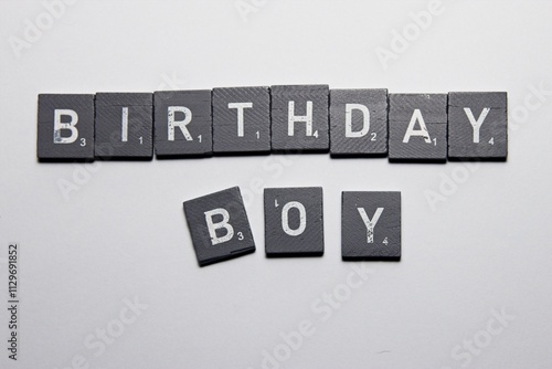 Gray Scrabble Letters making the word Birthday Boy, on a White background photo