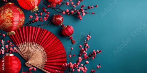 Lunar New Year flat lay with ornate lanterns, vibrant cherry blossoms, and traditional folding fans on a blue backdrop