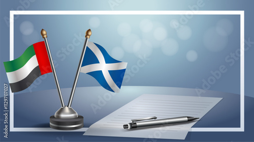 United Arab Emirate and Scotland National flags on small table with bokeh background, cooperative relationship
