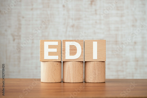 There is wood cube with the word EDI. It is an abbreviation for Electronic Data Interchange as eye-catching image. photo