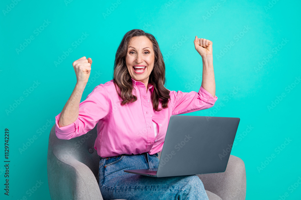 Photo of shiny excited lady dressed pink shirt sitting chair winning game modern gadget empty space isolated teal color background Photo of shiny excited lady dressed pink shirt sitting chair winning game modern gadget empty space isolated teal color background
