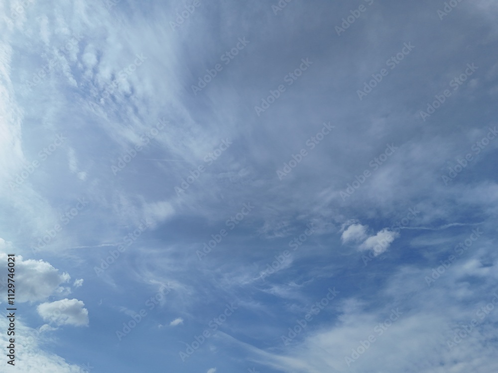 Bright summer sky filled with light clouds background Bright summer sky filled with light clouds background