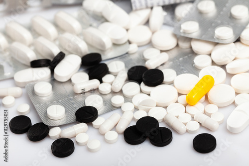 View of various pills and capsules on white background. Medical care concept