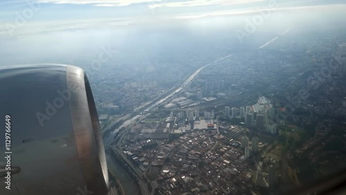 View through the airplane window during a flight over the city of Sao Paulo, passing over the Tiete River, Lapa region in the West Zone.