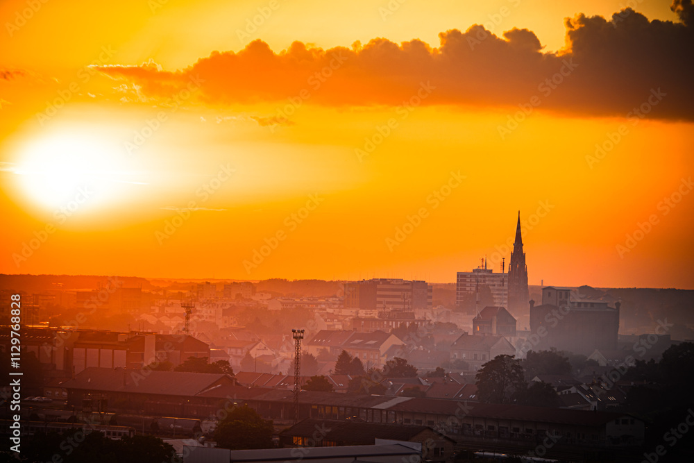 Naklejka premium Sunset over Osijek, Croatia with vibrant colors illuminating the skyline