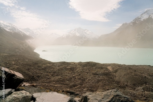 Tasman Lake on a Hazy Day, Serene Alpine Scenery in New Zealand photo