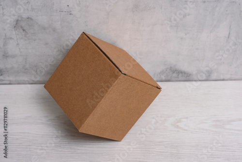 Eco friendly packaging sustainable shipping box on light background. Simple and sturdy packaging for product protection. photo