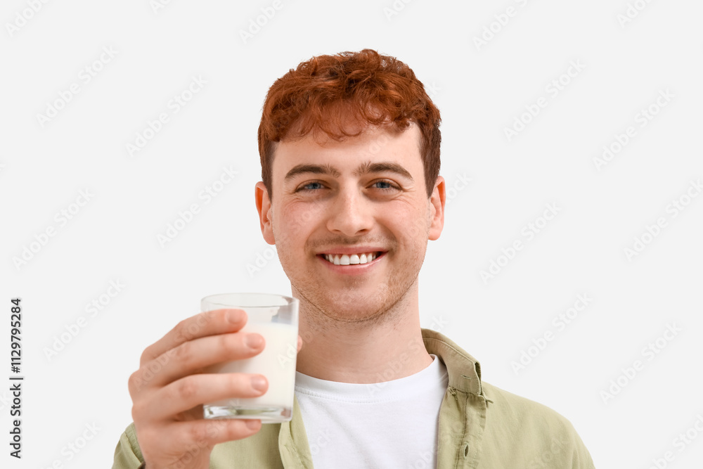 Young man with glass of milk on white background, closeup