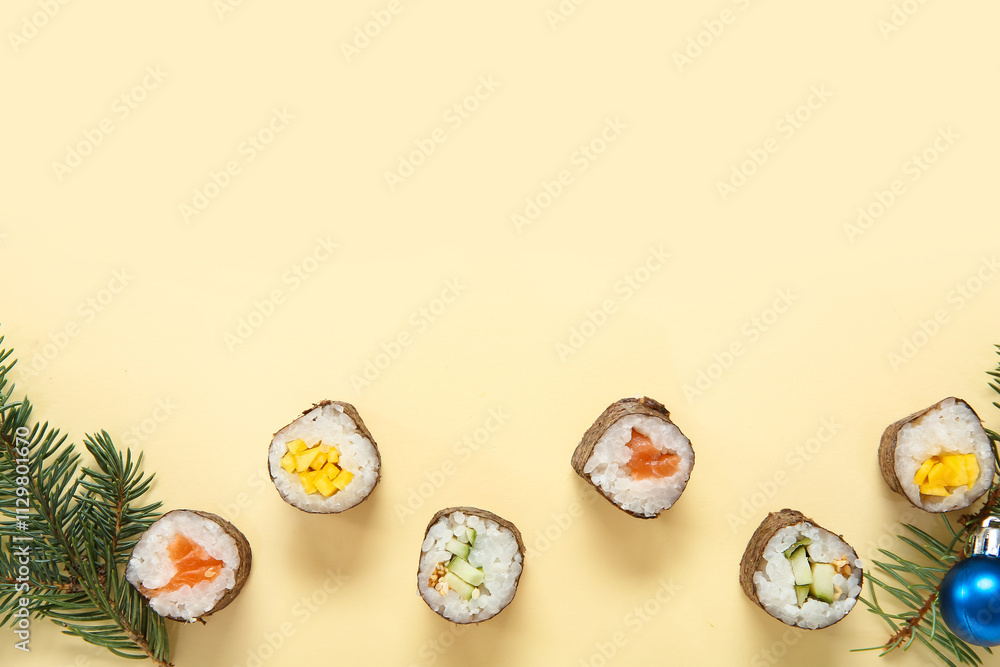 Christmas composition with tasty sushi rolls and fir tree branches on beige background Christmas composition with tasty sushi rolls and fir tree branches on beige background