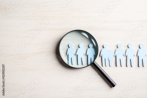 Magnifying glass focuses on group of people. Finding ideal candidate. Job hunt concept. Recruitment process. Headhunting strategy. Human resources department. Hiring. Job search. Resume submission. photo