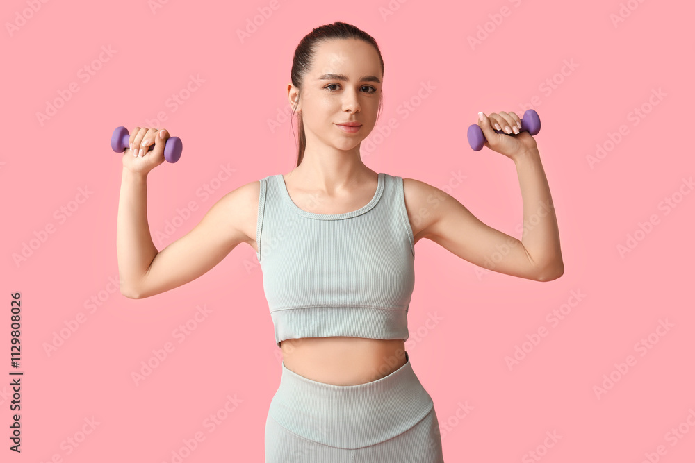 Young female trainer with dumbbells on pink background Young female trainer with dumbbells on pink background